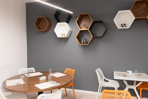 a dining room with a table and chairs at The ICONS Lisbon Hotel in Lisbon