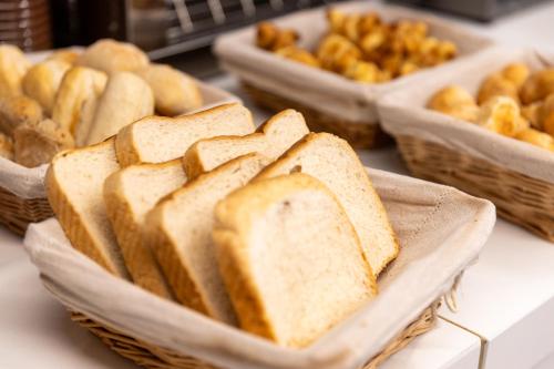 a group of baskets of bread on a table at The ICONS Lisbon Hotel in Lisbon