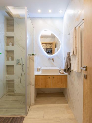 a bathroom with a sink and a mirror at My Savvas Studios in Haraki