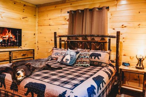 a bedroom with a bed with a dog laying on it at Creekside Cabin in Pigeon Forge