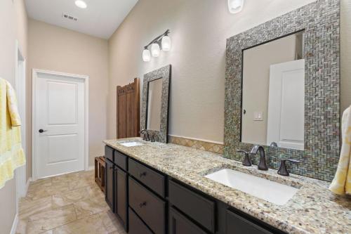 a bathroom with two sinks and a large mirror at Bend in the River in Georgetown