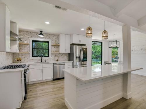 a kitchen with white cabinets and a white counter top at Cherilliam Estate in Round Rock