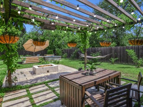 a backyard with a pergola and a table and chairs at Cherilliam Estate in Round Rock