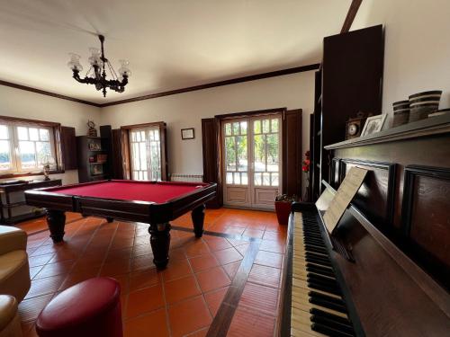 a living room with a pool table and a piano at Vagos Guest House in Vagos
