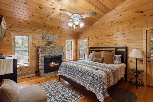 a bedroom with a bed and a fireplace at Beautiful Escape by American Patriot Getaways in Cove Creek Cascades