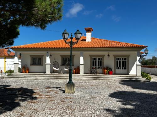 a house with a street light in front of it at Vagos Guest House in Vagos