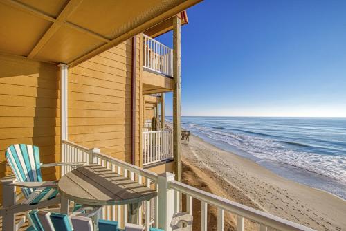 a balcony of a house with chairs and the beach at Topsail Dunes 1212 in North Topsail Beach