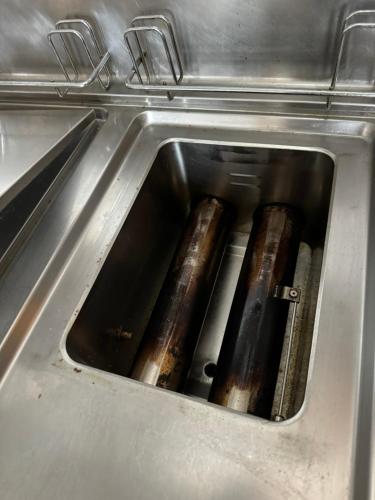 a stove with three logs inside of it at Gîte La Bavière in Chassepierre