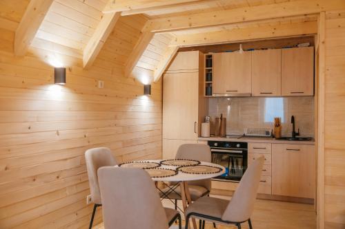 a kitchen and dining room with a table and chairs at Komovi Luxury House in Andrijevica