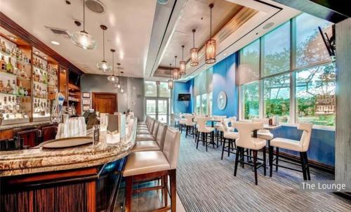 a restaurant with a bar with chairs and tables at Amethyst Studio Suite MGM Signature STRIP VIEW Balcony in Las Vegas