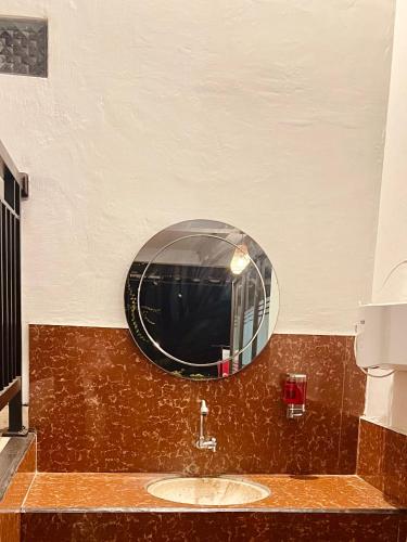 a bathroom with a sink and a mirror at Hostel KARMA by SEAOM Villas in Ubud