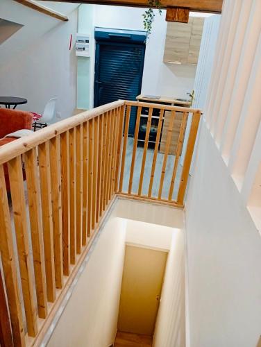 a wooden staircase in a living room with a stair case at Cozy Loft in Hazebrouck