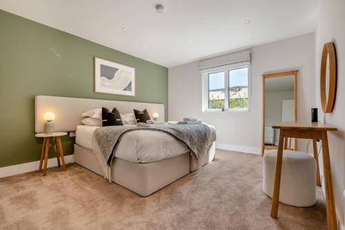 a bedroom with a large bed and a window at Fair Skies in St Merryn