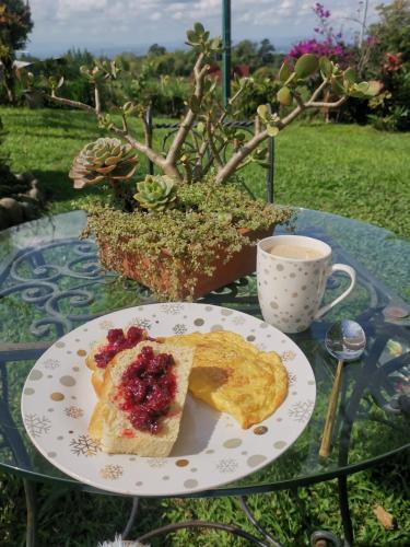 a plate of food on a table with a cup of coffee at Betania Alojamiento Rural Quindío Eje Cafetero espectacular! in Circasia