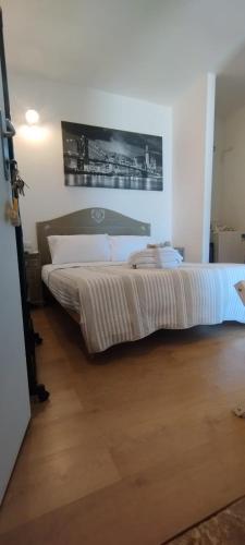 a large bed in a room with a wooden floor at Le Dimore Nel Borgo in Casamassima