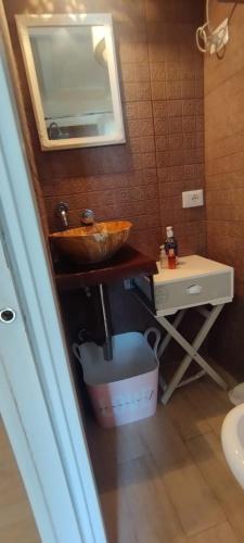 a bathroom with a sink and a vanity with a mirror at Le Dimore Nel Borgo in Casamassima