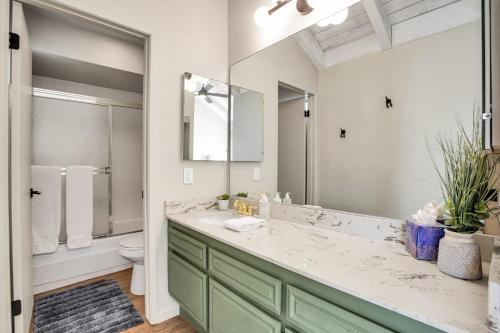 a bathroom with a sink and a toilet and a mirror at Desert Blue River Retreat in Palm Springs