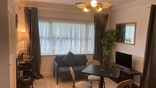 a living room with a blue couch and a window at Gra accommodations athy in Athy