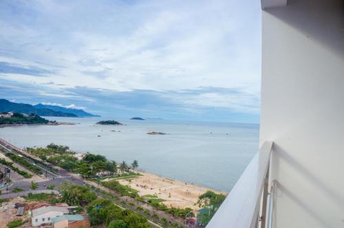 a view of the beach from the balcony of a building at Gem Nha Trang Hotel in Nha Trang