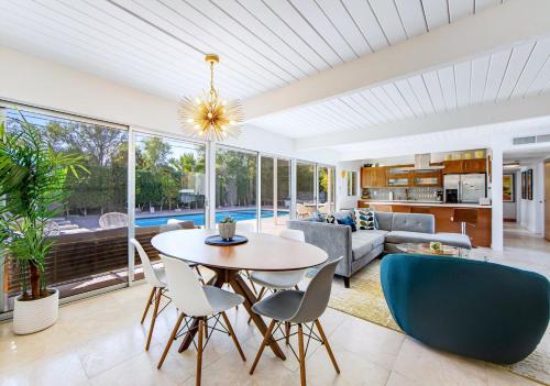 a living room with a table and chairs at Serenity in Sunmor in Palm Springs