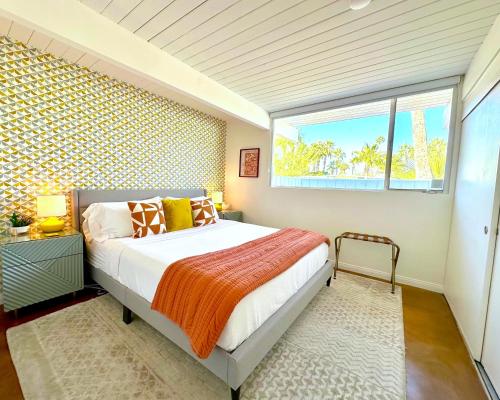 a bedroom with a large bed and a window at Serenity in Sunmor in Palm Springs