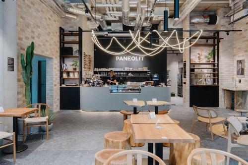 a restaurant with tables and chairs and a chandelier at Pekanda apartment in Brno