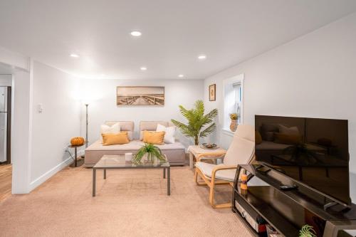 a living room with a couch and a flat screen tv at Prestigious 2 Bedrooms 2 Baths in West Point Grey in Vancouver