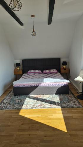 a bedroom with a bed with a rug and two tables at Elb Front in Winsen Luhe