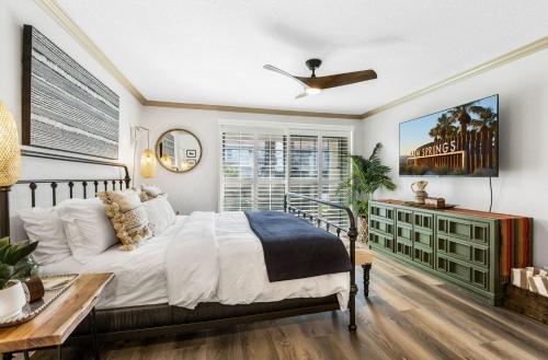 a bedroom with a bed and a ceiling fan at Cozy Ranch-Style Condo in Palm Springs