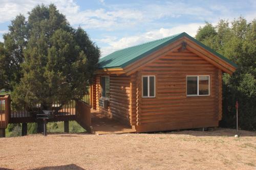 a small wooden cabin with a green roof at Sevier River Ranch & Cattle Company in Hatch