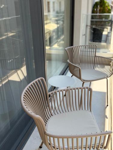 two chairs and a table on a balcony at Space Row Exclusive Residences in Heraklio Town