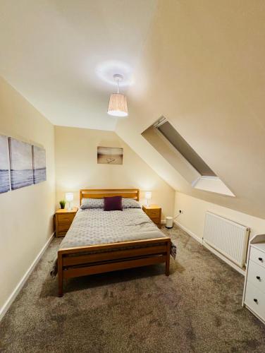 a bedroom with a bed and a vaulted ceiling at The Henge House in Salisbury