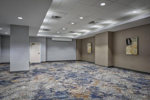 a large room with gray walls and a carpet at Courtyard Fort Worth Downtown/Blackstone in Fort Worth