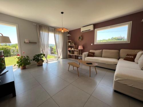 a living room with a couch and a table at Le temps de vivre in Mormoiron