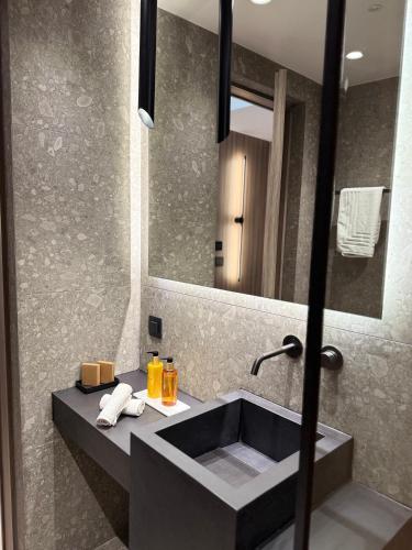 a bathroom with a sink and a mirror at Space Row Exclusive Residences in Heraklio Town