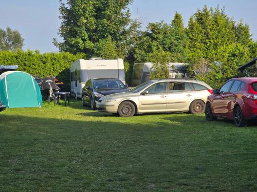 a group of cars parked in a field with tents at Camping - Park Władysławowo in Władysławowo