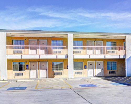 an apartment building with balconies and a parking lot at Nites Inn in Killeen