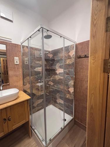 a glass shower in a bathroom with a sink at Quiet and Cozy 3BR Apartment Near Center and Airport in Rīga