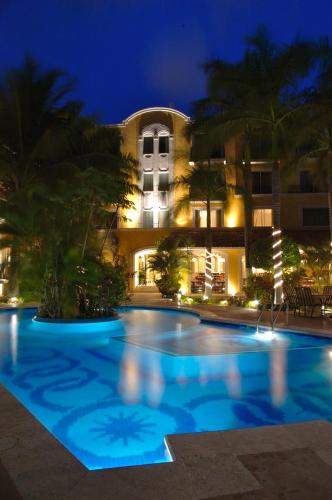 a swimming pool in front of a building at night at Hotel Hacienda Real in Ciudad del Carmen