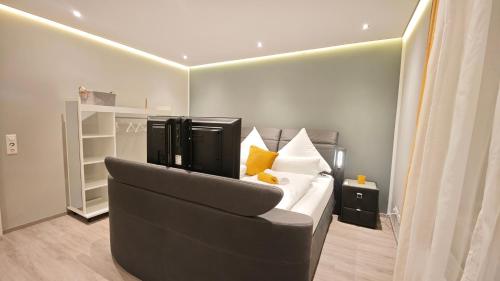 DANESSI-Familie,Business,nahe Koblenz,6 Personen,Saniert,direkte Anbindung Industriegebiet,TV Kingsize Boxspringbett في مولهايم-كيرليش: غرفة نوم بسرير مع أريكة وكرسي