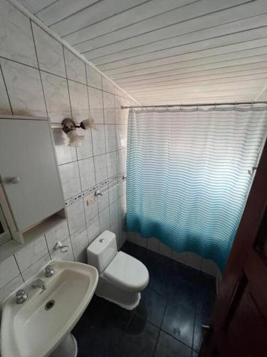 a bathroom with a toilet and a sink at Casa Luma in Puerto Montt