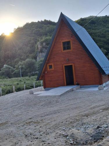 a small wooden building with a door on a hill at Whisper of the Pliva in Šipovo