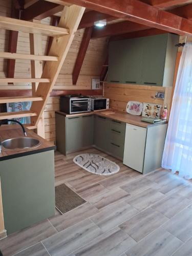 a small kitchen with a sink and a stove at Whisper of the Pliva in Šipovo