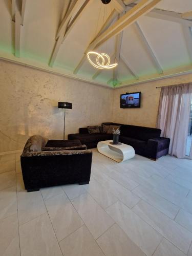 a large living room with couches and a tv at Vikendica Konstantin Slatina-Banja Luka in Laktaši