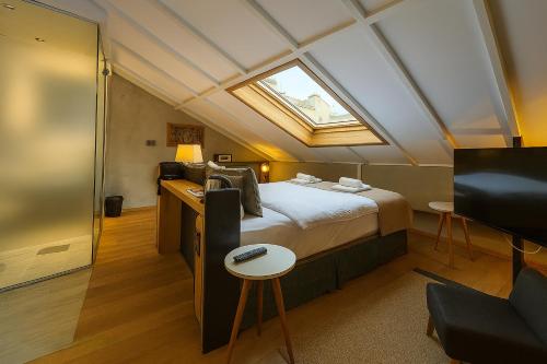 a bedroom with a bed and a skylight at Aleksandr Pera Hotel in Istanbul