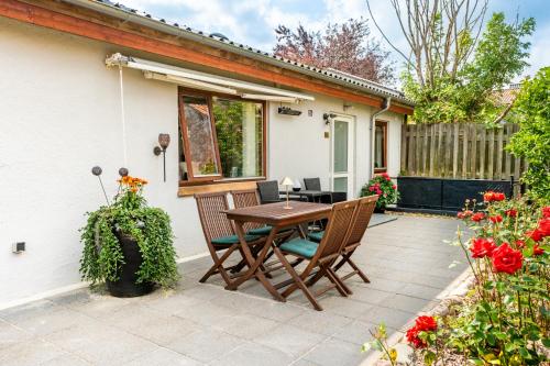 a patio with a wooden table and chairs at Skylight Lodge in Horsens