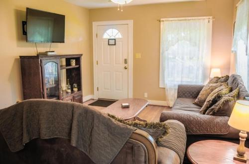a living room with a couch and a tv at Home Away from Home 2 bedroom house in Bay City
