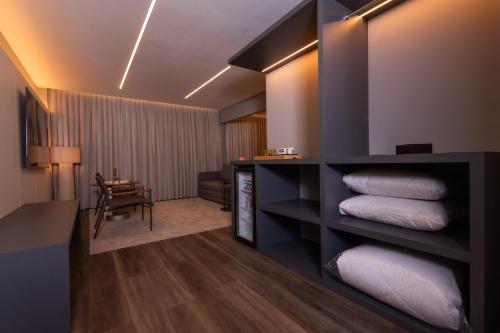 a hotel room with a pile of white pillows at Hotel Le Canard Lages in Lages