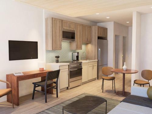 a kitchen with wooden cabinets and a table and chairs at Mint House Tampa - Downtown in Tampa