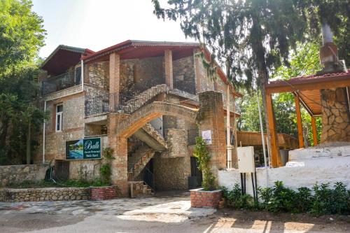 a stone building with a staircase in front of it at Ballı Butik hotel in Kayakoy